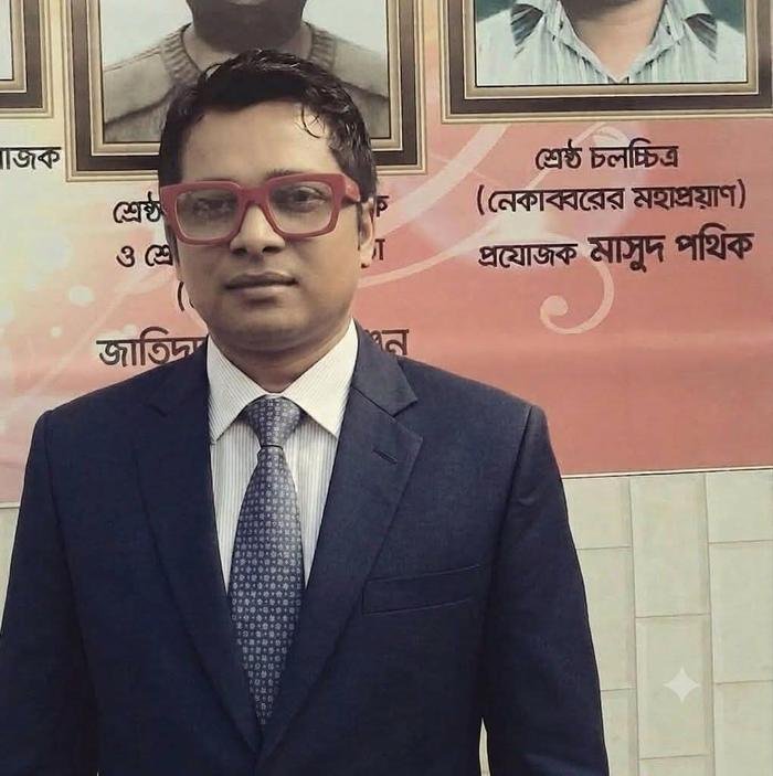 Masud Pathik in front of the National Film Award banner
